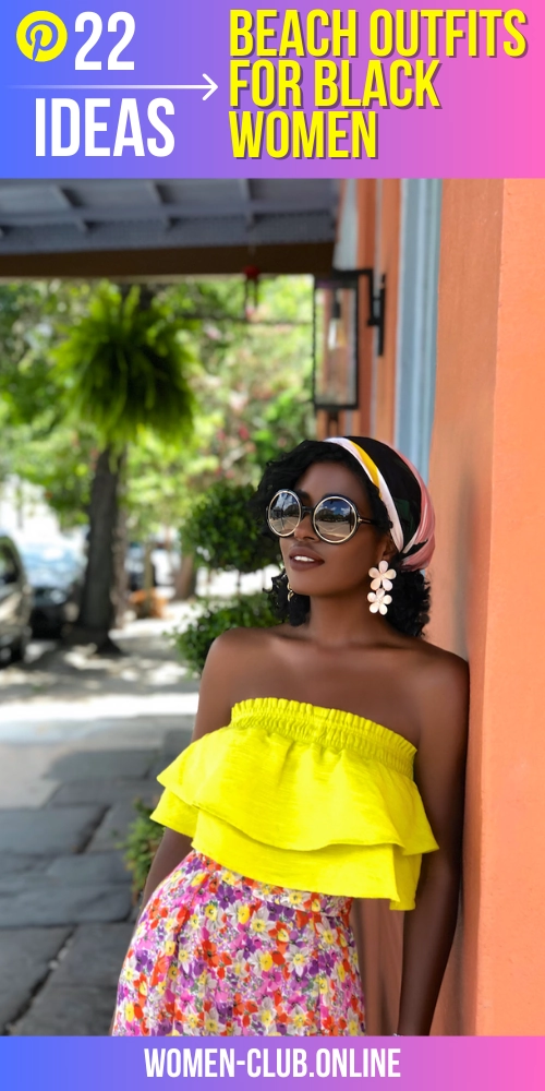 Afro beach vacation style with voluminous curly hair, a floral kimono, and shell earrings