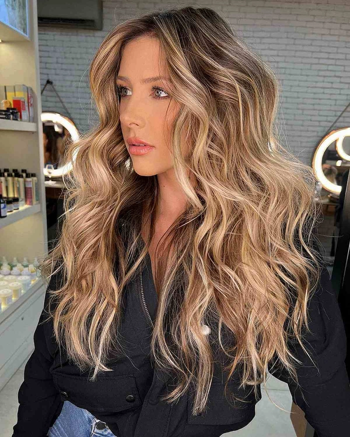 Woman with babylights beach wave enhancement, soft blonde highlights and tousled texture