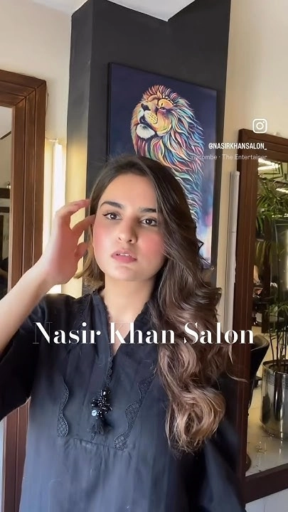 Subtle babylights enhance loose beach waves for a sun-kissed summer hairstyle