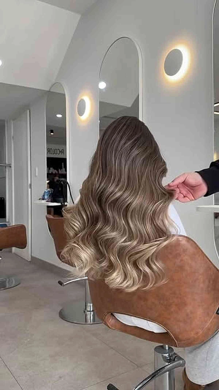 Woman with babylights and beach wave enhancement hairstyle for a casual summer look