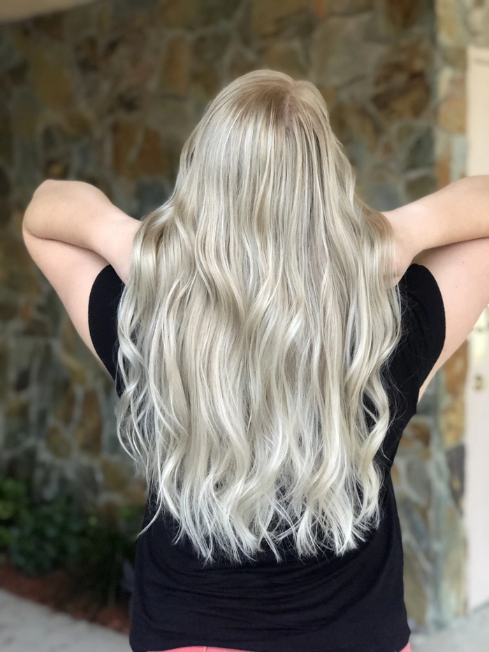Woman with babylights beach wave enhancement, soft blonde highlights and tousled texture
