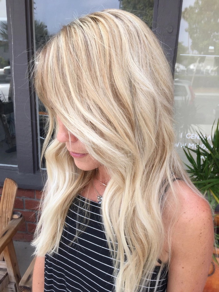 Woman with balayage beach wave styling and tousled hair by the ocean