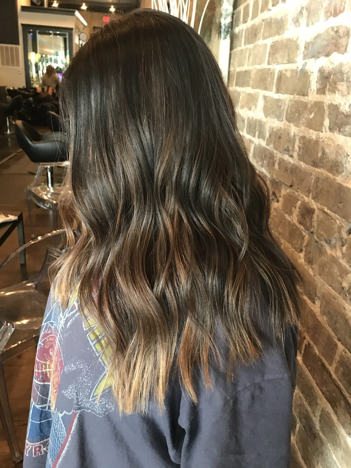 Woman with balayage beach waves styling for a relaxed summer look