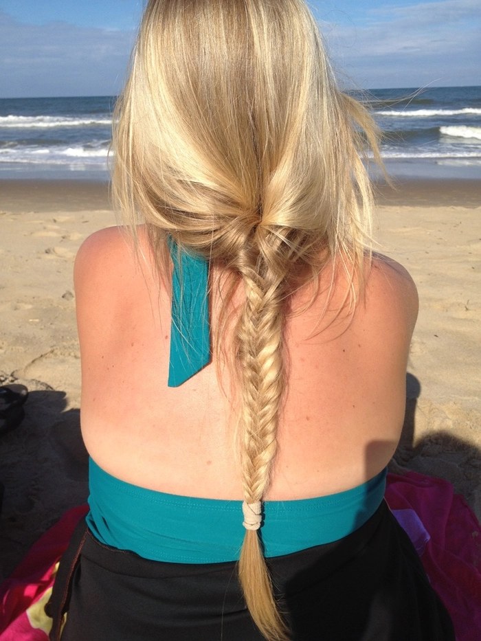 Woman with extra long beach braids flowing in ocean breeze