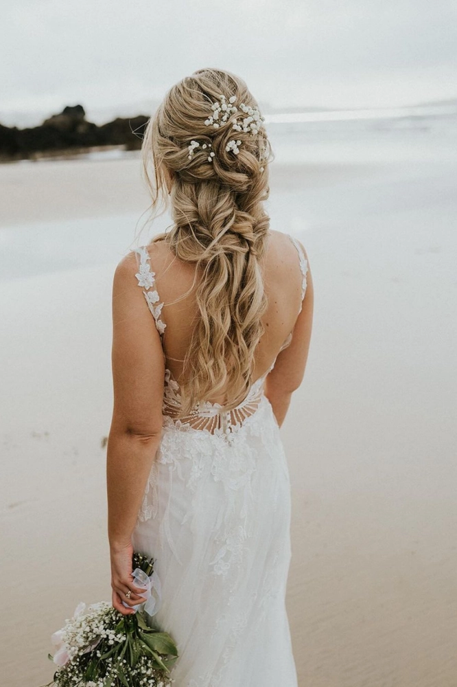 Boho beach bridesmaid hairstyle with braided accents and sea breeze texture Beach bridesmaid hair concept with soft waves and tropical flowers