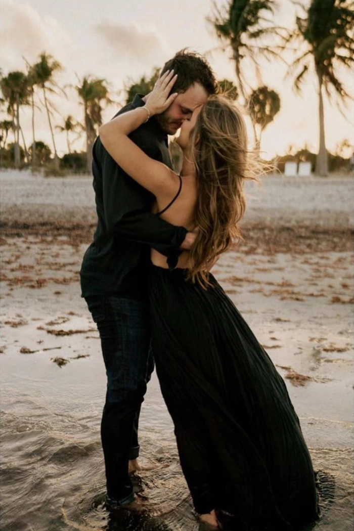 Best beach engagement session hair trends for a romantic oceanfront shoot Bride with beachy waves and braided crown on the shore at engagement session