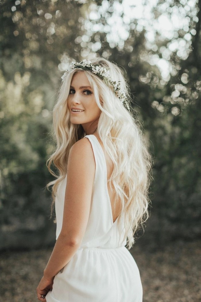 Woman with messy bohemian braids and floral accessories at a beach festival