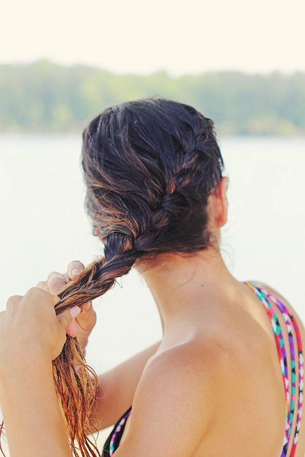 Woman with beach french braid hairstyle and seashell accessories