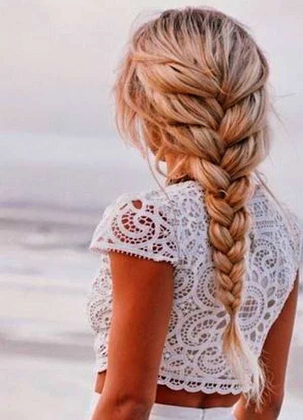 Woman with a beach french braid showcasing effortless summer hairstyle aesthetics
