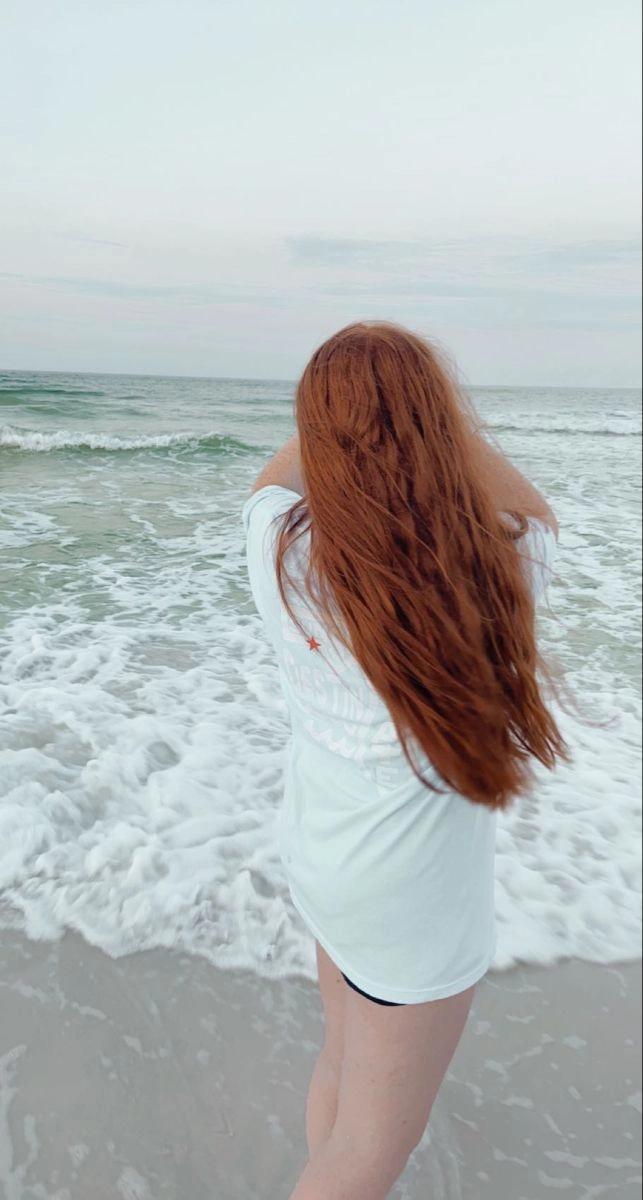 Redhead with beachy waves and sun-kissed hair at the shore