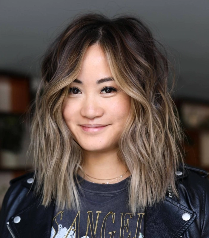 Soft beach waves framing a round face with sun-kissed highlights
