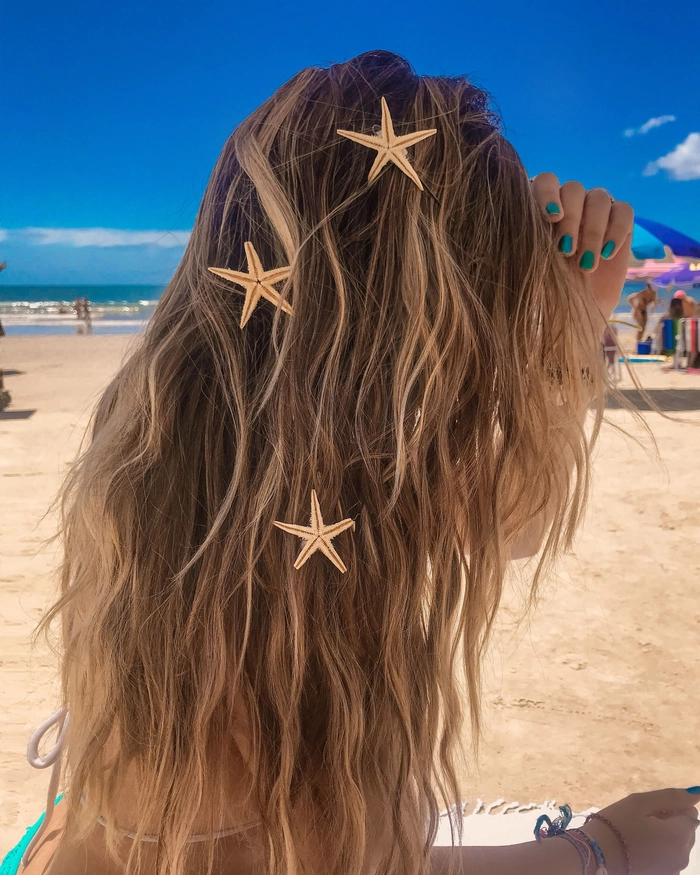 Elegant gold leaf detailing woven into a beach hairstyle Beach waves accented with delicate pieces of gold leaf