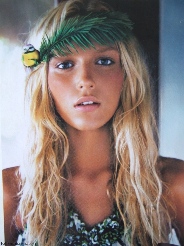 Beach waves adorned with shimmering gold leaf for an elegant seaside look Beach hairstyle with delicate gold leaf accents woven through soft waves