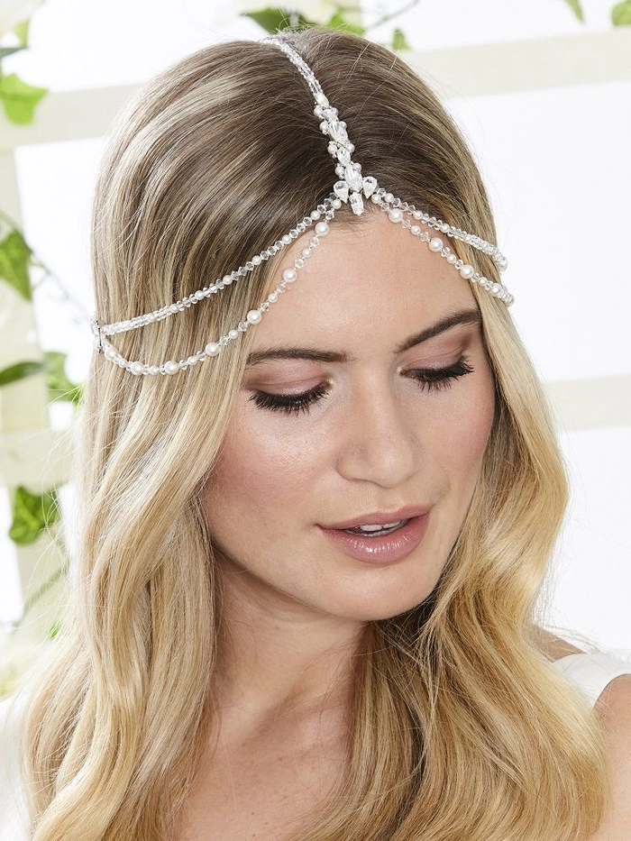 Gold leaf accents in beach hair for a radiant summer style Beach hair with gold leaf accents adding shimmering details to flowing waves