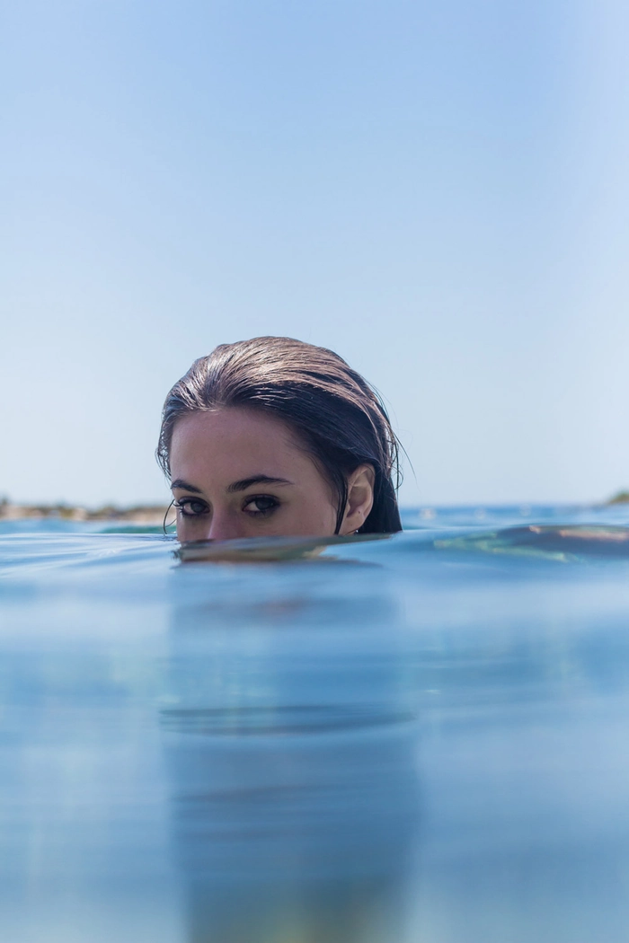 Woman with tangled saltwater-kissed beach hair after swimming