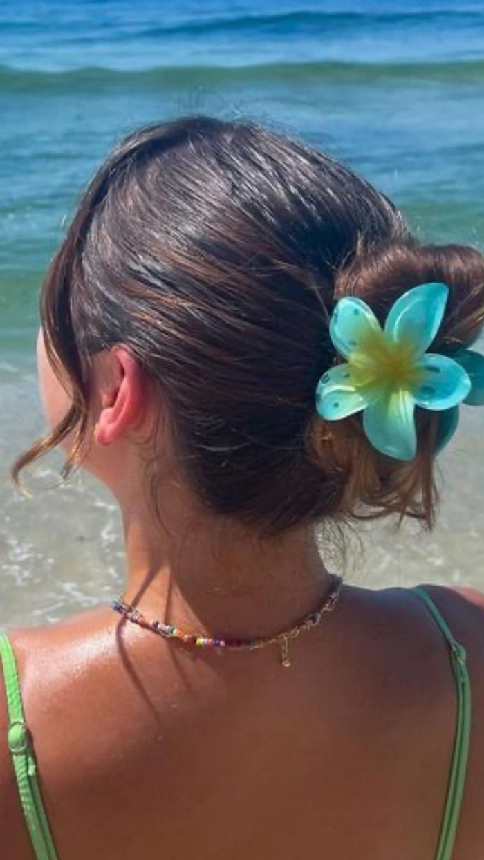 Beach hair with fresh tropical flowers woven through waves