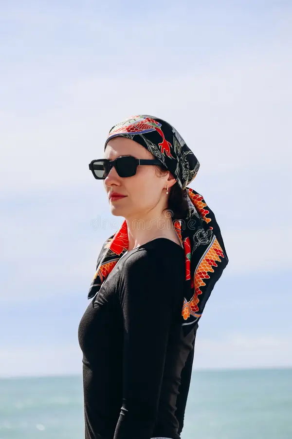 Silk scarf beach hairstyle for summer Beach hair styled with a colorful silk scarf