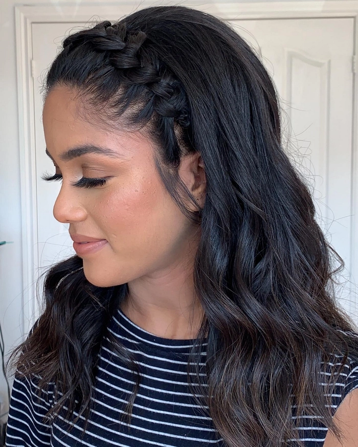 Women's beach hairstyle featuring a woven headband Beach hair styled with a woven headband in a sunny seaside setting