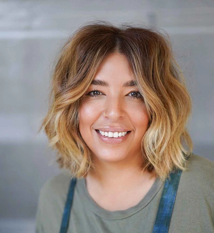 Woman with short hair styled in beachy waves by the ocean