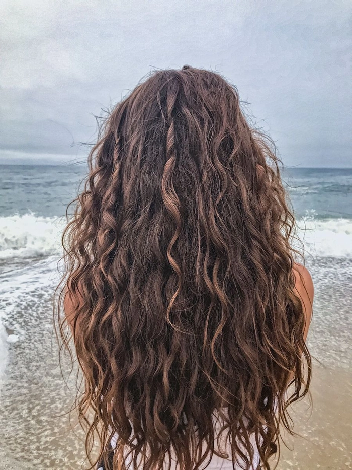 Effortless beach waves with natural curls catching the sea breeze
