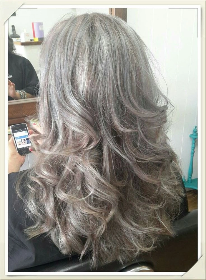 Silver and gray beach hair blowing in the ocean breeze