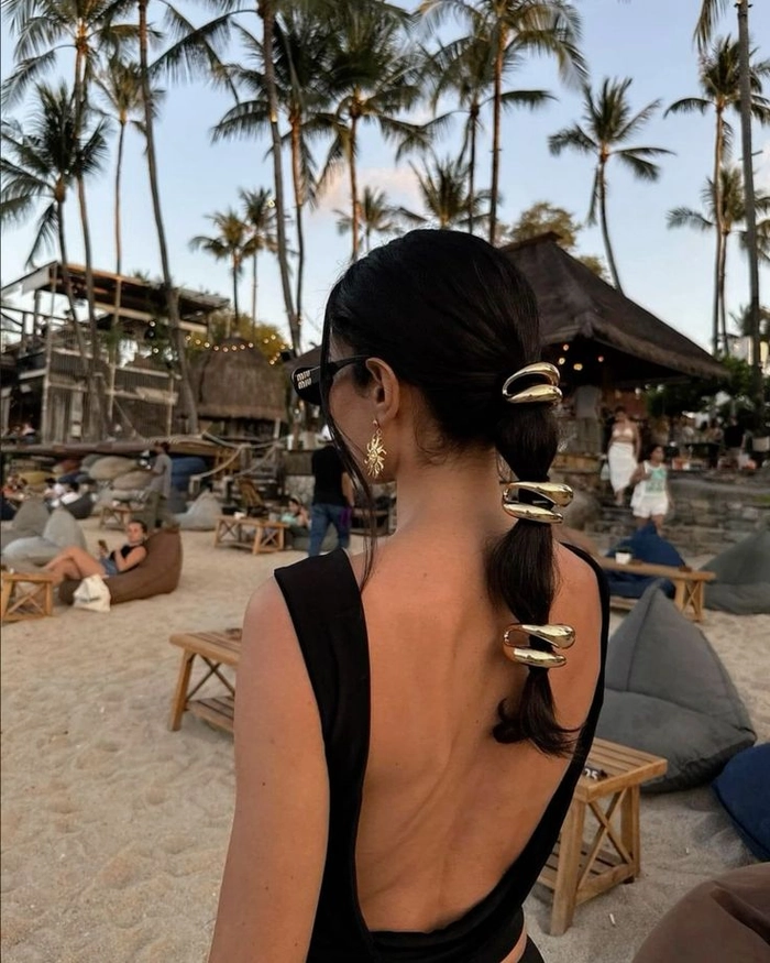Night beach party hairstyle with wavy hair glowing under party lights