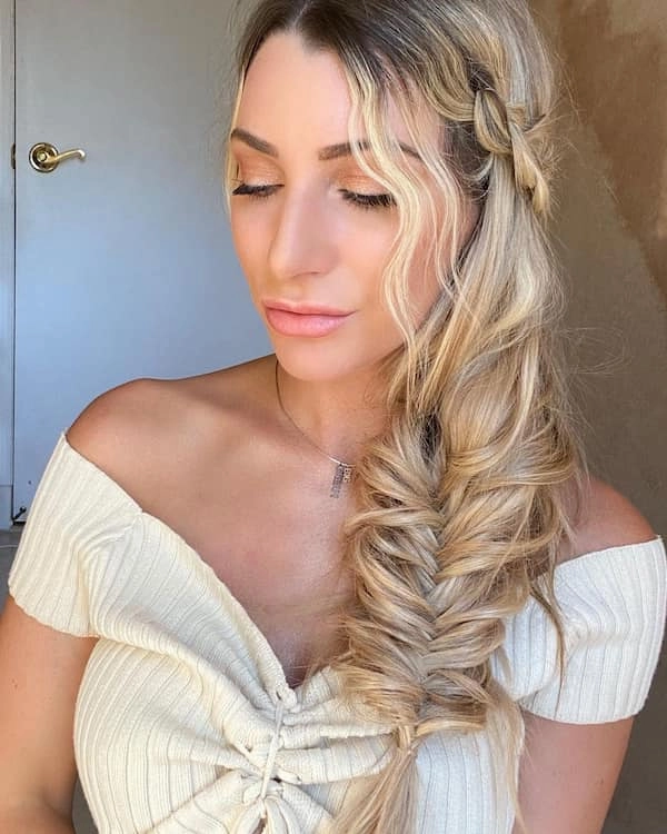A relaxed side braid with loose waves on a sunny beach