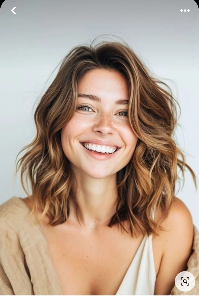 Soft beachy waves created on medium length hair with a tousled finish