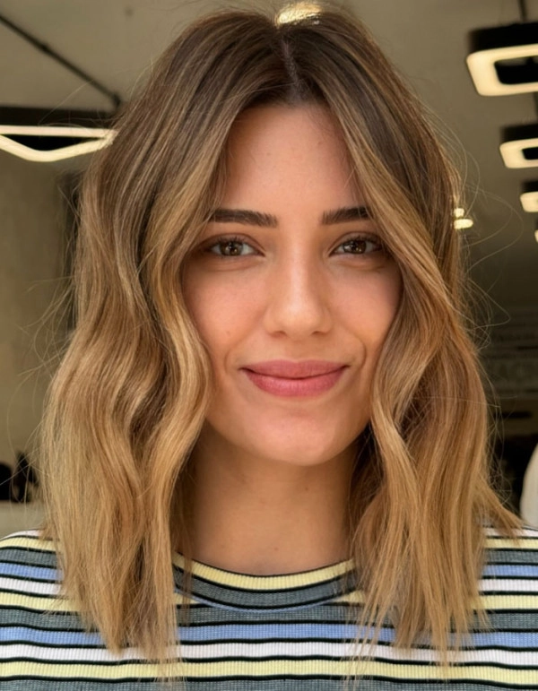 Woman with a stylish bob cut enjoying a sunny beach day
