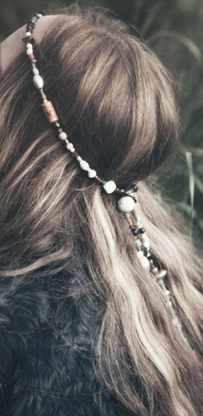 Woman with bohemian beach hair aesthetics, featuring tousled waves and a floral crown