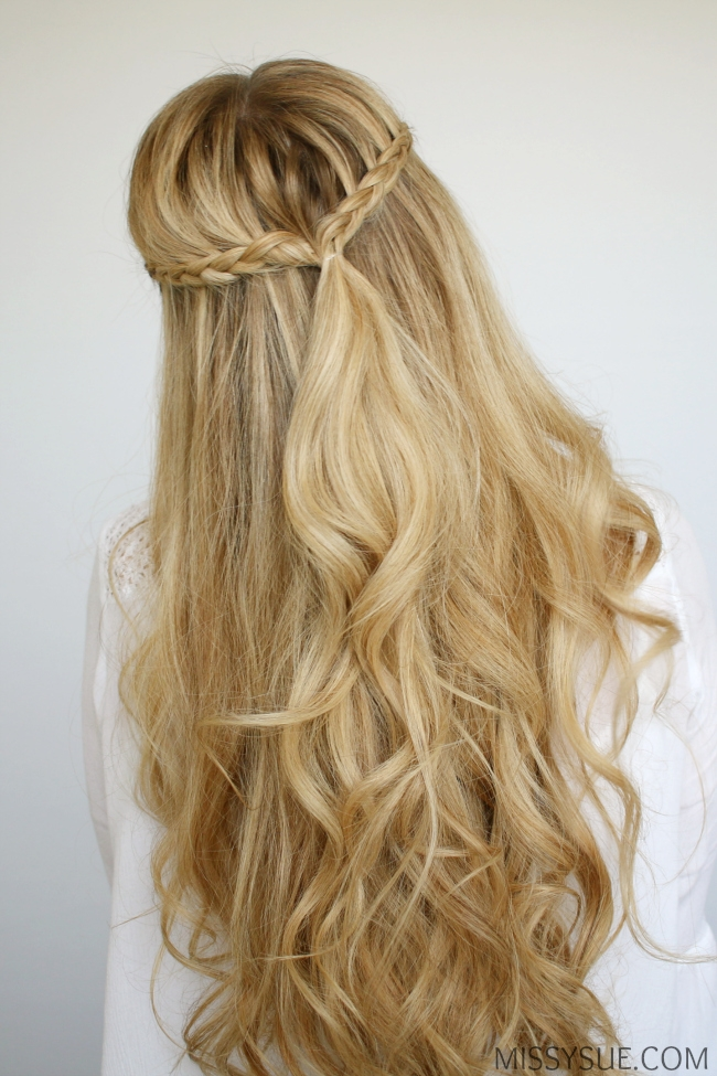 How to braid damp hair for effortless beach waves A woman braiding her damp hair to create loose beach waves