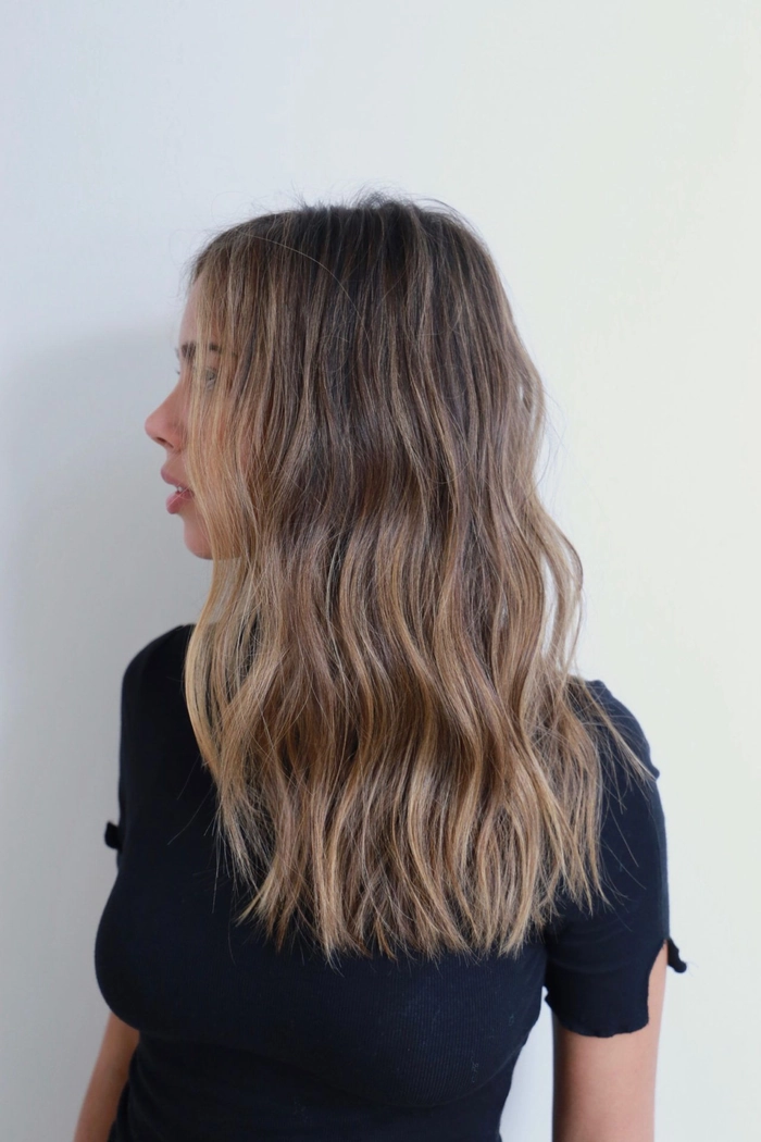 Brunette beach waves with soft dimensional body and sun-kissed highlights