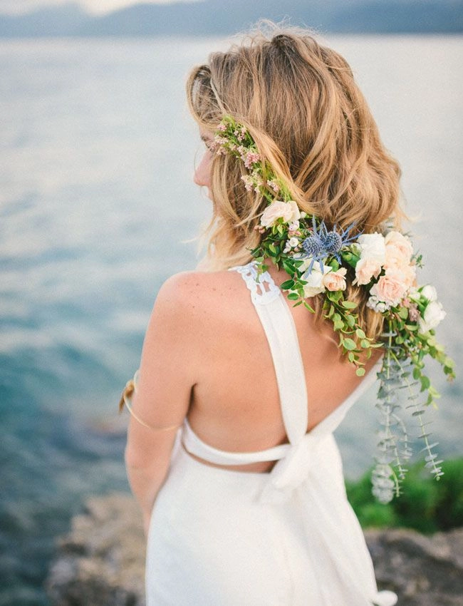 Coastal elopement hair inspiration featuring soft beach waves and a floral crown Bride with flowing waves and delicate flowers for coastal elopement hair inspiration