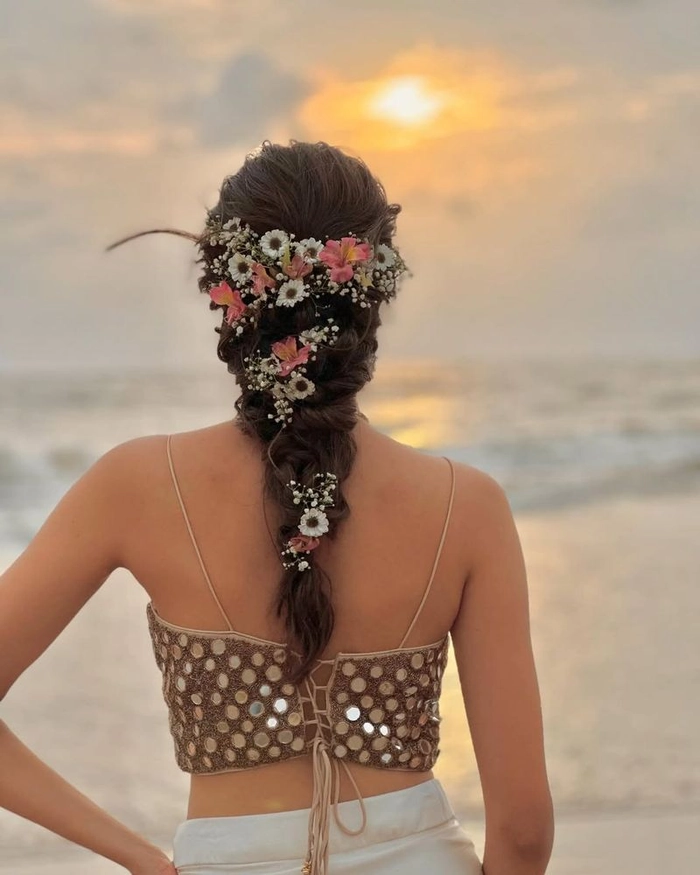 Protective beach hairstyle for coily hair featuring braids and soft waves Coily hair styled in a protective braided updo with seashell accents