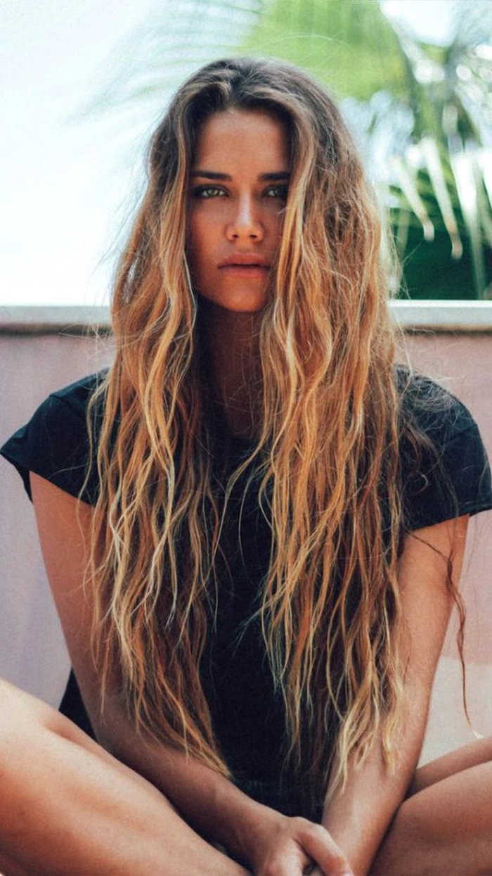 Spring break beach waves hairstyle for college students College student with wavy beach hair and a carefree smile on spring break