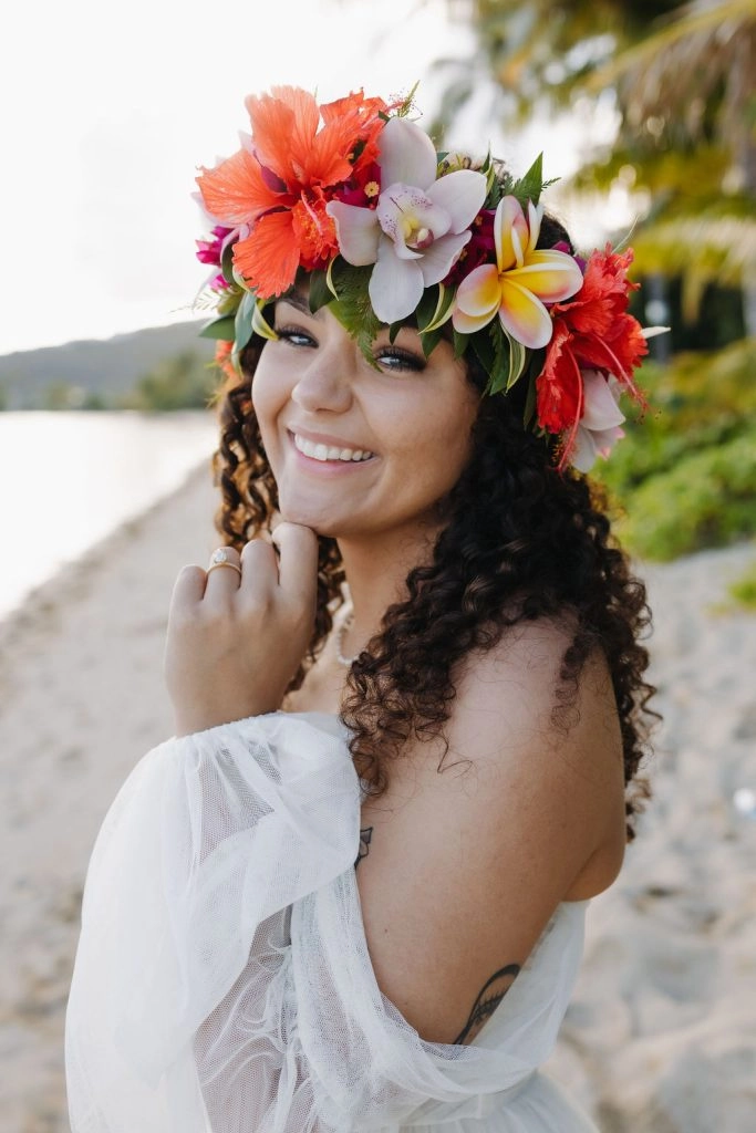 Romantic destination wedding beach hair styled with soft waves and tropical white blooms Bride with loose beach waves and a floral crown at a sunset destination wedding ceremony
