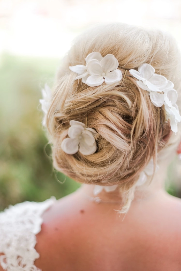 Bride with flowing beach waves and floral accents for a destination wedding Elegant beach wedding hairstyle for a destination bride with soft waves and flowers