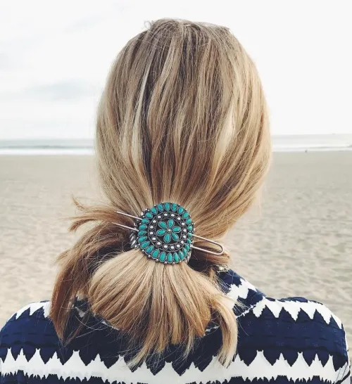 Edgy beach hairstyle with statement accessories and windswept texture