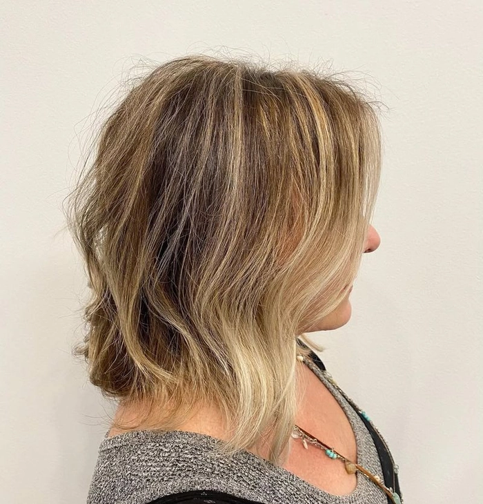 Elegant beach hairstyle for older women with silver waves blowing in the breeze