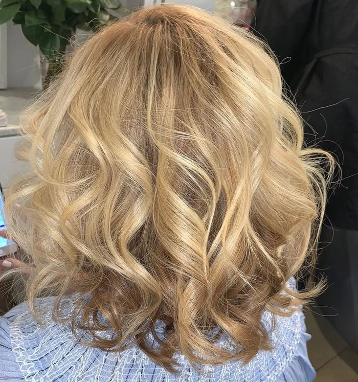 Older woman with elegant beach waves and a soft updo at the shore