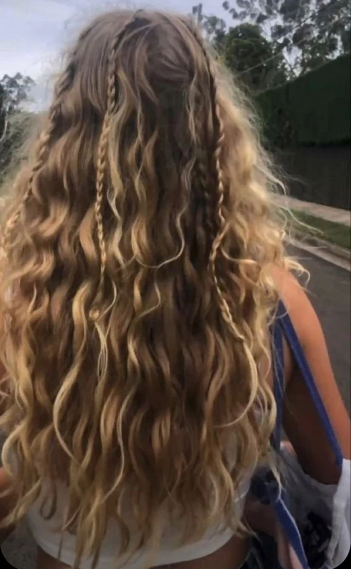 Woman with extra long beach braids flowing in the ocean breeze