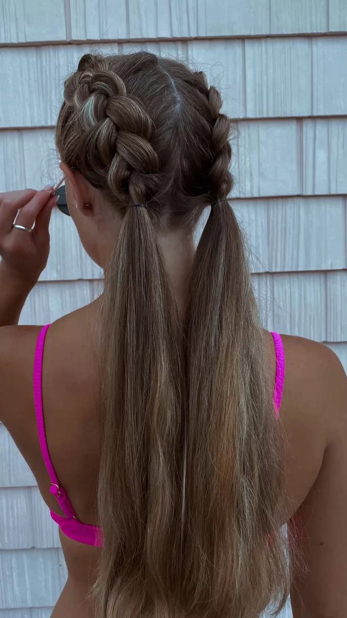 Extra long beach braids cascading down a woman's back on a sunny shoreline