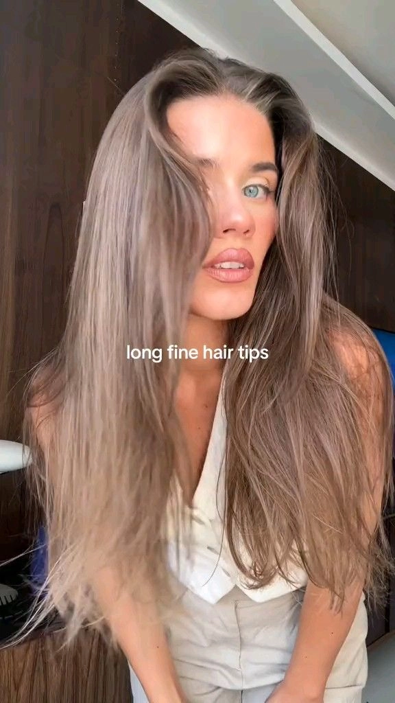 Woman with fine hair demonstrating beach volume tips using soft waves and tousled ends
