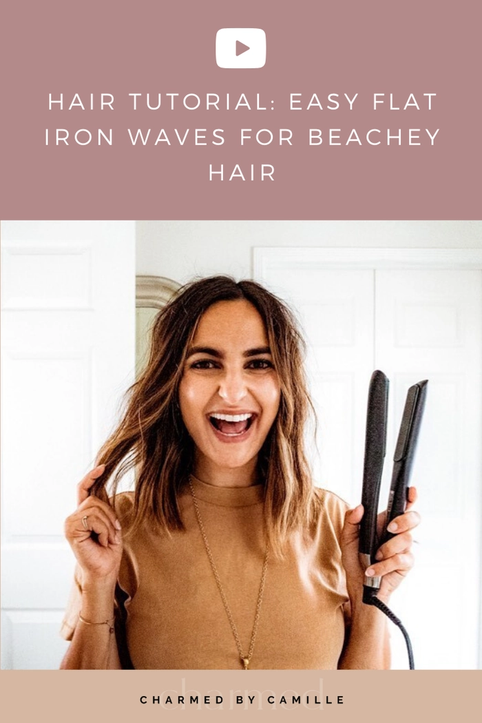 Woman styling beach waves with a flat iron on dry hair at the beach
