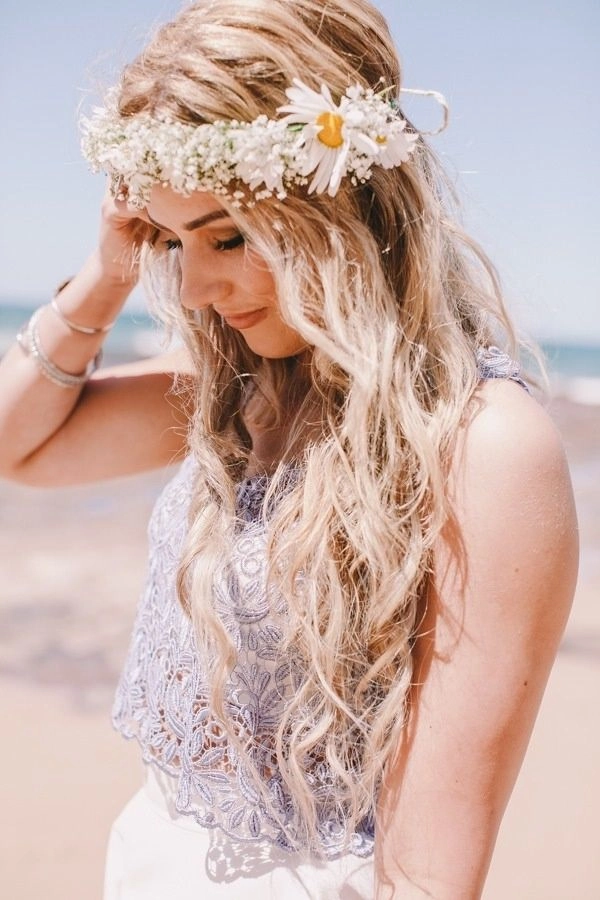 Woman wearing a floral crown with flowing beach waves