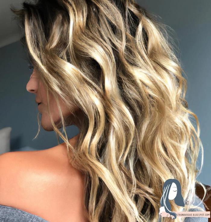 Glamorous beach wave hairstyle with loose curls and golden highlights