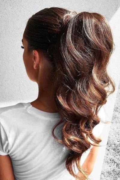Stylish high ponytail beach hairstyle with wavy texture and sun-kissed highlights
