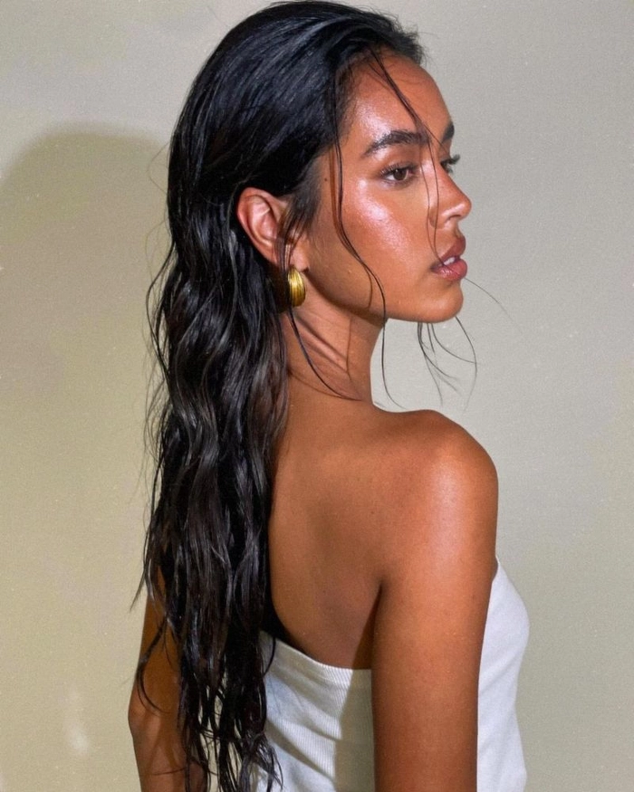 Shiny wet look beach waves hairstyle trend for a modern coastal look
