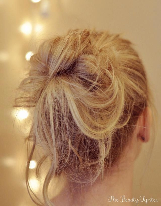 Effortless messy beach bun with loose tendrils for a sun-kissed casual look