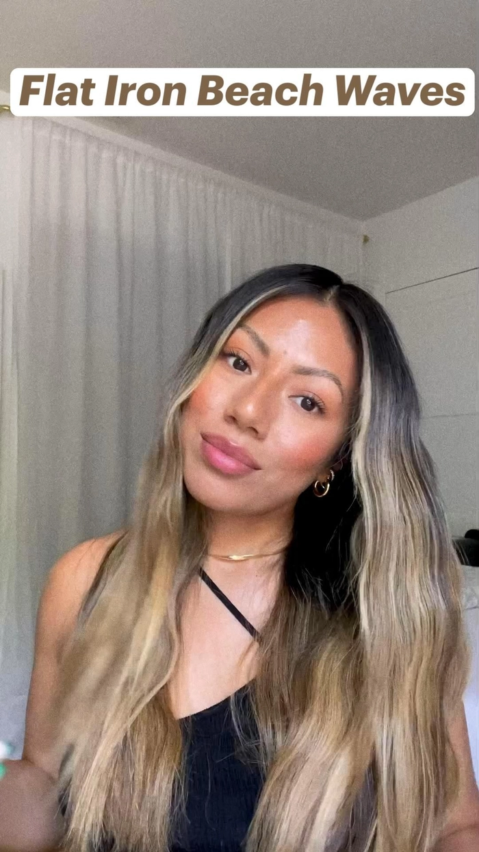 Using a flat iron to create soft beach waves on long hair